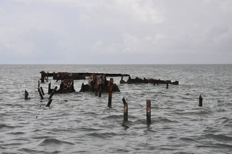 To promote ecological restoration of Horn Island, the National Park Service, with support from the NOAA Marine Debris Program (MDP), spearheaded a large collaborative effort to assess and remove this sunken barge. (Credit: NOAA).