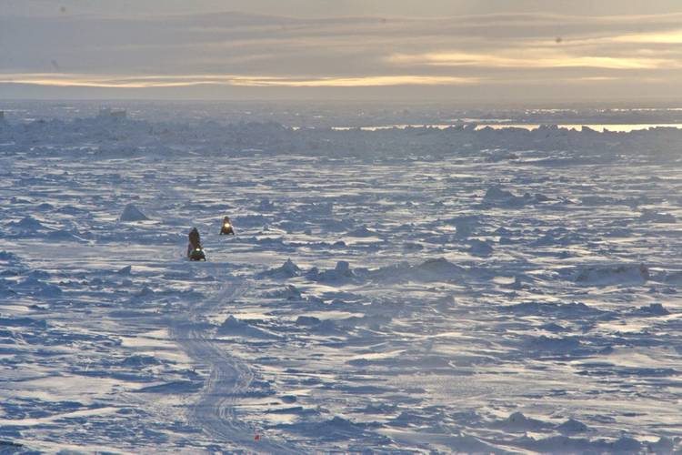 Residents of Utqiagvik return by snowmachine from the lead at the edge of the shore-fast ice. Photo by Andy Mahoney, UAF Geophysical Institute