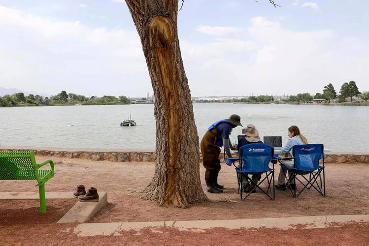 From left to right: UTEP doctoral student Jayanga Thanuka Samarasinghe, alumnus
Fernando Sotelo and Assistant Professor Laura Alvarez observe the boat from shore as it maps Ascarate Lake’s
underwater terrain. Credit: The University of Texas at El Paso.