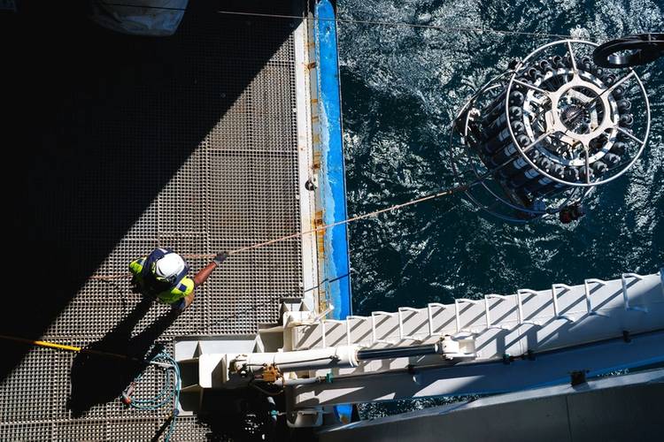 Robert Keino (Bosun) assists in recovering the CTD rosette. "CTD" stands for conductivity, temperature, and depth, and refers to a package of electronic devices used to detect how the conductivity and temperature of water changes relative to depth.
Credit: Alex Ingle / Schmidt Ocean Institute