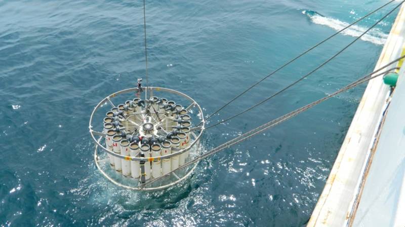 A rosette sampler carrying 24 empty Niskin bottles is deployed into the Pacific to collect samples of water after the Fukushima nuclear accident. (Photo by Irina Rypina, Woods Hole Oceanographic Institution)