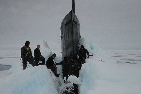 Sailors aboard USS Seawolf remove Arctic ice from the hull after surfacing at the North Pole. (U.S. Navy photo)
