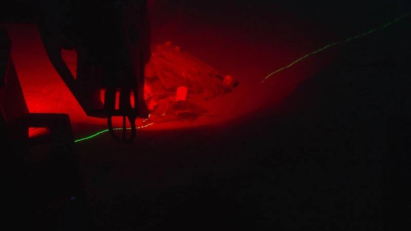 Scanning Marine Debris: 
Scanning the same marine debris using red ambient light and a complimentary green laser.
Image courtesy of Kraken Robotics and the NOAA Office of Ocean Exploration and Research. 