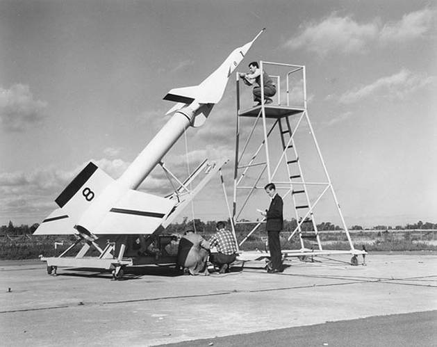Avro technicians prepare an Avro Arrow test model attached to a Nike booster rocket to fire out over Lake Ontario at Point Petre in the 1950s (Image: Kraken)