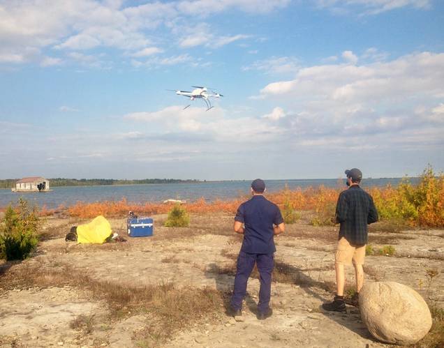 An Unmanned Aircraft System (UAS) takes off from Thunder Bay Island under the supervision of its pilots. (Image courtesy of Thunder Bay National Marine Sanctuary, NOAA)