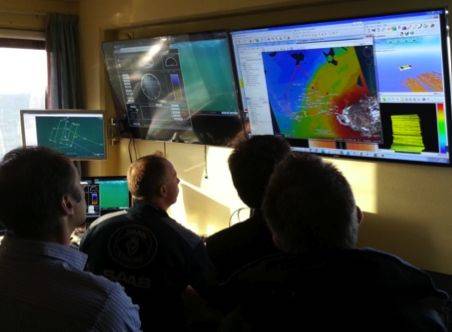Visitors examining live survey data transmitted from the Sabertooth (Image: Saab Seaeye)