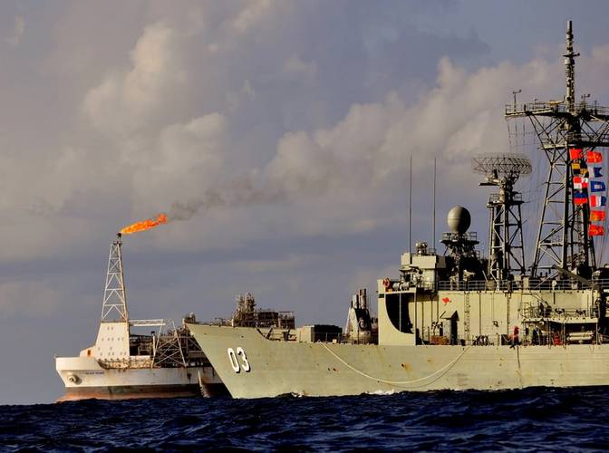 HMAS Warramunga conducts a twilight patrol around the natural gas production facility, Prod Bayu-Undan, as the ship and crew of HMAS Warramunga conduct a maritime security patrol in the Timor Sea as part of Ex Blue Raptor 2013. Photo: LSIS Brenton Freind