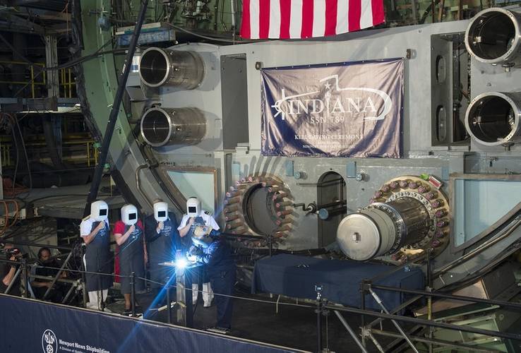 A welder carves the initials of ship's sponsor Diane Donald on a metal plate during the keel laying ceremony for the future Virginia-class attack submarine Indiana (SSN 789). (U.S. Navy photo courtesy of Huntington Ingalls Industries by Ricky Thompson)