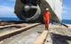 Ardent naval architect Roland De Marco walks in front of the bow piece of the Troll Solution after the salvage team cut and lifted it from the seabed. (Photo: Ardent)