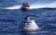 Boats carrying Navy divers and NASA's recovery team guide the capsule to the USS Anchorage as the ship safely operates on station (Photo: NASA)