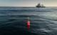 The bright floats of the in-situ 'Cocktail' incubator (Chamber Oxygen Collector Kit Tracer Analyser Insitu Logger) can be seen on the surface of the ocean. Beneath, a robotic system made from glass and titanium called the Submersible Incubation Device (SID) is suspended in the water column. Two SIDs are attached and mounted on this drifting mooring, floating in the Ocean for 24 hours per deployment. The automated system will act like giant glass syringes, pulling water into four chambers. Tracer