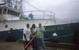 Captain Scott Drabinowicz with crew holding the tagging stick in front of the FV Eagle Eye II.