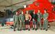 A Coast Guard Air Station Corpus Christi MH-65 Dolphin helicopter aircrew stands with two rescued divers after they were located and rescued Saturday, June 27. (U.S. Coast Guard photo)