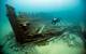 A diver surveys the wreck of Lucinda Van Valkenburg, a wooden three-masted schooner that sank just north of Middle Island in 1887. (Photo: Tane Casserley/NOAA)