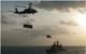 An MH-60S Sea Hawk helicopter, assigned to the "Sea Knights" of Helicopter Sea Combat Squadron (HSC) 22, transports supplies over the guided-missile cruiser USS Gettysburg (CG 64) during a replenishment-at-sea with the aircraft carrier USS Harry S. Truman (CVN 75) in the Arabian Gulf. (U.S. Navy photo by Seaman Karl Anderson)