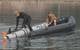 U.S. Navy Lt. j.g. Jeff Morehead (left) and Electronics Technician 2nd Class William Stark, with Explosive Ordnance Disposal Mobile Unit (EODMU) 5, pull a MK18 Mod 2 unmanned underwater vehicle onto a tow sled at Jinhae-gu, Republic of Korea (ROK) March 31, 2016 during exercise Foal Eagle 2016. (U.S. Navy photo by Charles E. White)