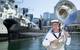 Musician Leading Seaman Martyn Hancock who composed the musical piece "March of the Silent Service" stands in front of decommissioned submarine HMAS Onslow at the Australian National Maritime Museum, Darling Harbour, Sydney. (Photo: Tom Gibson)