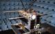 NORsat-1 in EMC test at SFL. Two AIS antennas may be seen at the top, and four Langmuir probes off to the sides. The solar wings of the satellite are at the bottom. (Photo: Space Flight Laboratory)