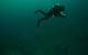 Phase IV started with a series of ‘work-up’ dives used to practice technical diving techniques and refine the photogrammetric imagery acquisition protocols before visiting deeper sites. Here, NOAA Diver Joe Hoyt swims above the debris field off the stern of wooden bulk carrier New Orleans. He maintains a consistent altitude off the bottom, necessary to ensure broader coverage of the debris field features as the relate to the main vessel remains. (Credit: NOAA, Thunder Bay National Marine Sanctua