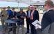Rhode Island Secretary of Commerce Stefan Pryor (center, from left) and U.S. Sen. Sheldon Whitehouse get a demo on the latest swarming technology from Aquabotix during the Advanced Naval Technology Exercise (ANTX) 2019 held on Aug. 29 at the Naval Undersea Warfare Center Division Newport. (by Public Affairs Officer Jeff Prater)