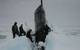 Sailors aboard USS Seawolf remove Arctic ice from the hull after surfacing at the North Pole. (U.S. Navy photo)