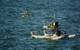 A Seabotix ROV is lowered into the water from a WAM-V, with a Z-Boat 1800RP nearby (Photo: Eric Haun)